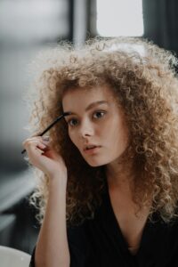 Woman-in-White-Fur Coat Holding-Black-Pen 